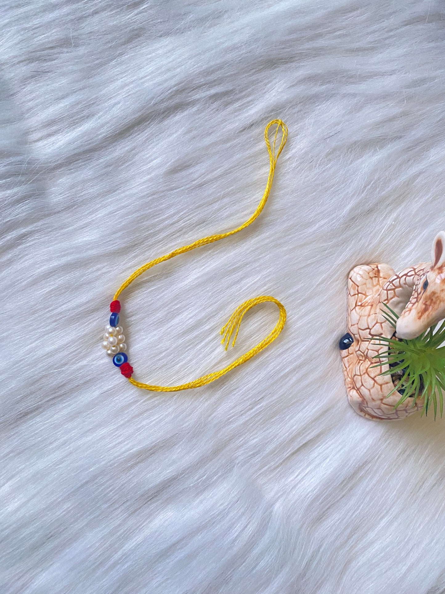 Bright Yellow Thread Rakhi with Pearls & Evil Eye Beads